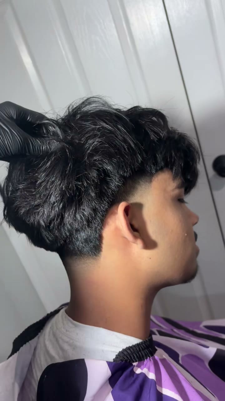 Majeed cutting a client's hair at his Ashburn, VA home barber studio